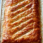 Maple-Dijon Ham and Gruyère Puff Pastry Slab Golden brown baked puff pastry slab on a parchment-lined baking sheet.