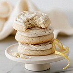 Stack of vanilla glazed lemon meltaway cookies on a ceramic stand