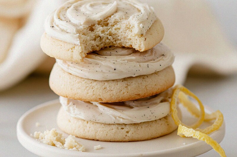Stack of vanilla glazed lemon meltaway cookies on a ceramic stand