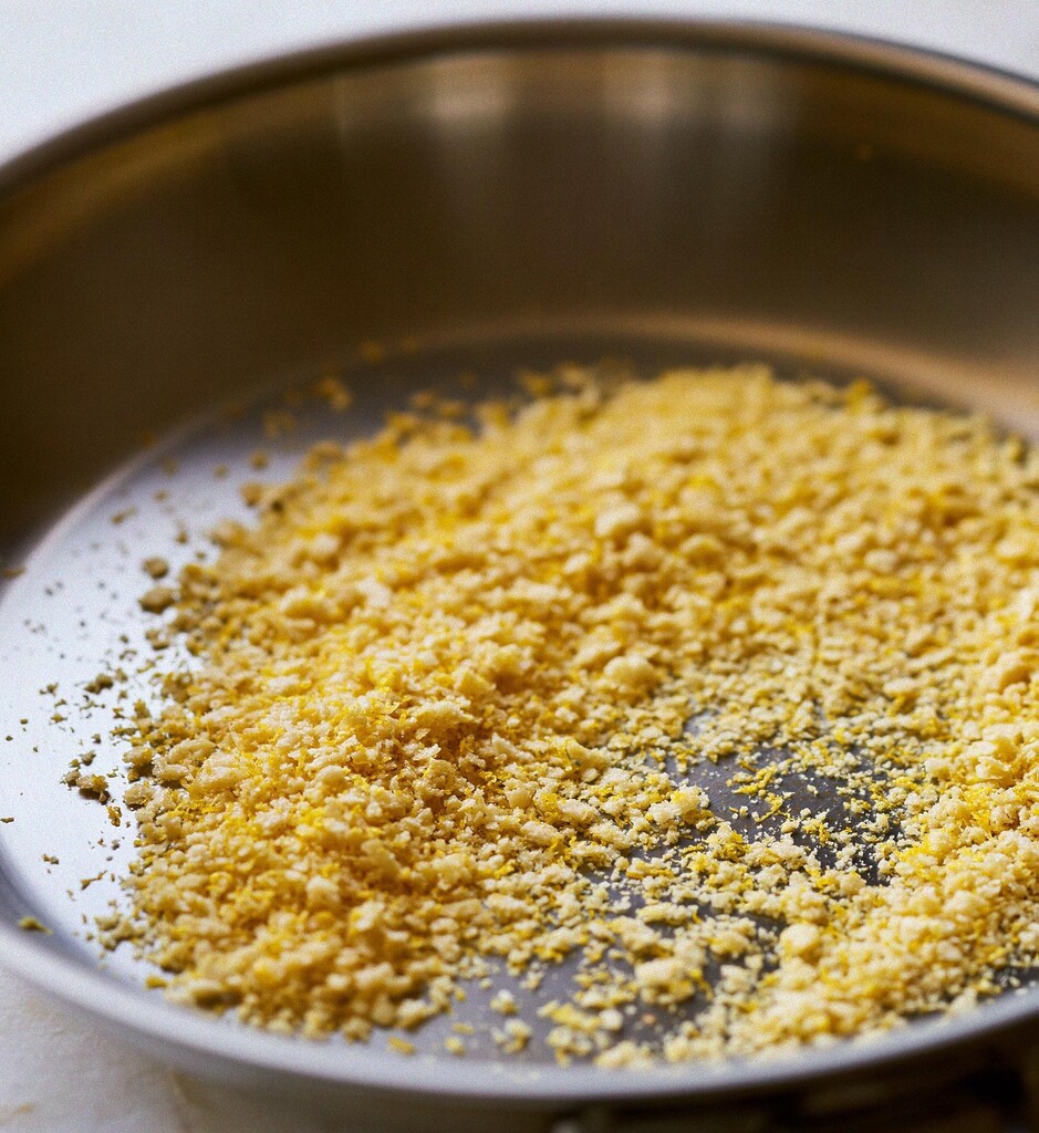 Golden panko breadcrumbs and fresh lemon zest toasting in a metal skillet