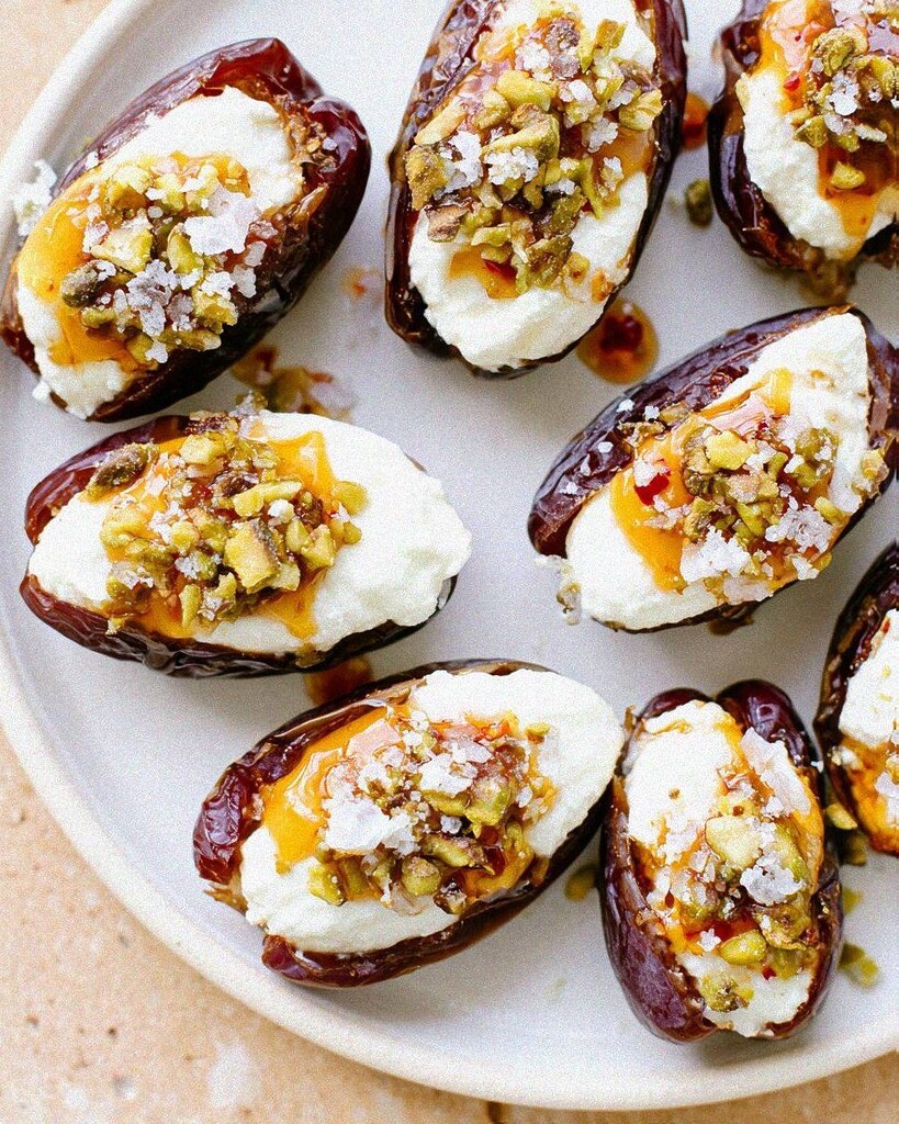 Overhead view of the finished stuffed dates covered in hot honey and pistachios