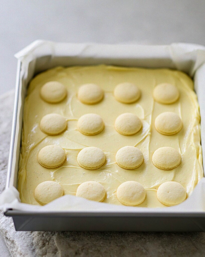 Vanilla wafer cookies pressed into a grid on top of the yellow pudding layer