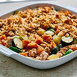 Ground turkey and sweet potato bake finished with a golden panko crust in a white ceramic baking dish