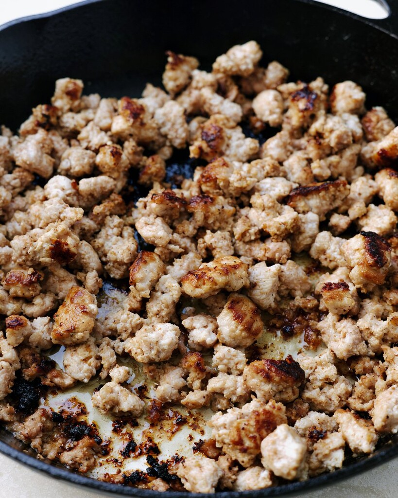 Ground turkey browning in a black cast iron skillet
