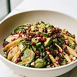 Honeycrisp Apple and Feta Salad Honeycrisp apple and feta salad ready to serve in a wide bowl with avocado, pomegranate, and crunchy nuts