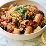 Roasted eggplant pasta in a light bowl topped with golden garlic breadcrumbs and fresh torn basil