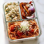 Divided glass meal prep container holding cilantro-lime rice, roasted peppers, and shredded salsa chicken