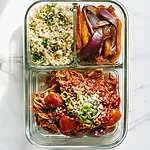Cilantro-Lime Salsa Chicken Meal Prep Bowls for a Week of Lunches Shredded salsa chicken with cotija cheese and scallions next to cilantro-lime rice in a glass meal prep container