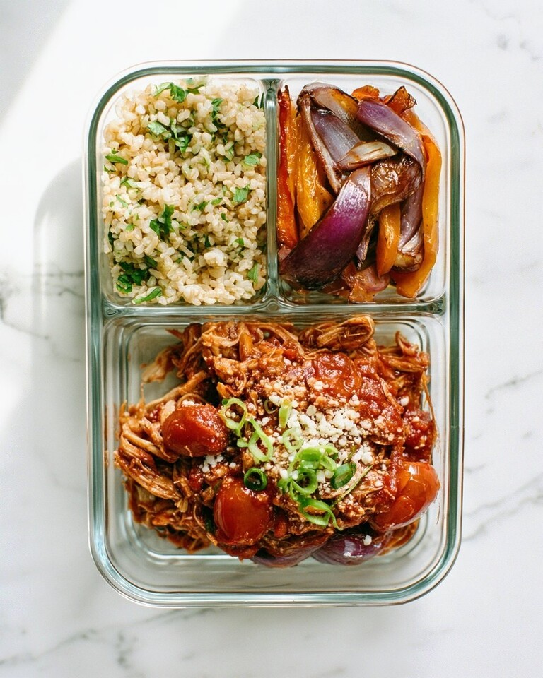 Cilantro-Lime Salsa Chicken Meal Prep Bowls for a Week of Lunches Shredded salsa chicken with cotija cheese and scallions next to cilantro-lime rice in a glass meal prep container