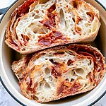 Parmesan-Crusted Pepperoni Pizza Sourdough Slices of pepperoni pizza sourdough bread in a deep dish showing an airy crumb and melted cheese pockets
