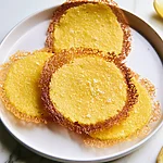 Upside-Down Parmesan Polenta Bites With a Shattered Crust Crispy upside-down parmesan polenta bites served on a white plate with golden lacy cheese edges