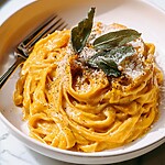 Serving butternut squash alfredo with crispy sage and black pepper in a light dish
