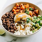 Sweet-Heat Hot Honey Beef and Sweet Potato Bowls Hot honey beef and sweet potato bowl garnished with avocado, cheese, seeds, and cilantro