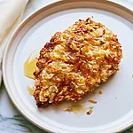 Hot Honey Potato Chip Chicken with an Ultra-Crispy Crust Hot honey potato chip chicken on a white plate with a glossy golden crust
