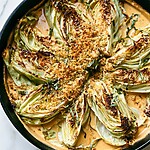 Marry Me Cabbage wedges in a creamy sauce topped with golden panko and fresh basil in a skillet