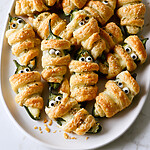 Everything Bagel Mummy Jalapeño Poppers (Quick Crescent Dough) Mummy jalapeño poppers served on a white plate with candy eyes