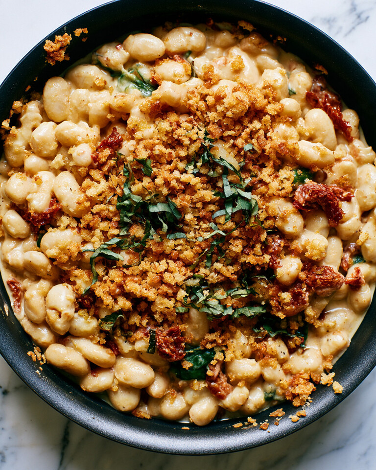 Creamy Marry Me White Beans with Garlic Panko Black skillet filled with creamy white beans topped with golden panko crumbs and fresh basil