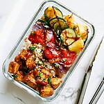 Charred Pineapple and Teriyaki Tofu Meal Prep Bowls for Four Days Glass meal prep container filled with rice, grilled teriyaki tofu, charred pineapple chunks, and grilled vegetables