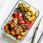 Charred Pineapple and Teriyaki Tofu Meal Prep Bowls for Four Days Glass meal prep container filled with rice, grilled teriyaki tofu, charred pineapple chunks, and grilled vegetables