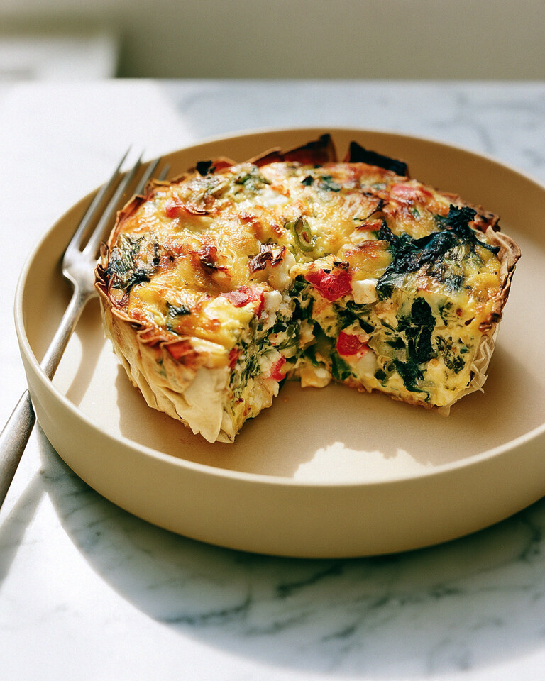 Easy High-Protein Tortilla Quiche with a Crispy Cheese Rim Baked high-protein tortilla quiche cut into sturdy slices on a serving plate with a golden, crispy cheese rim