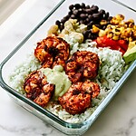 Fully assembled blackened shrimp bowl in a glass meal prep container