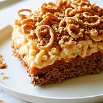 Served slice of mac and cheese meatloaf on a white plate with a clear view of the crunchy topping
