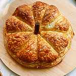 Hot Honey Pumpkin Butter Baked Brie in Flaky Puff Pastry Golden pumpkin-shaped hot honey pumpkin butter baked brie topped with a cinnamon stick stem and flaky sea salt