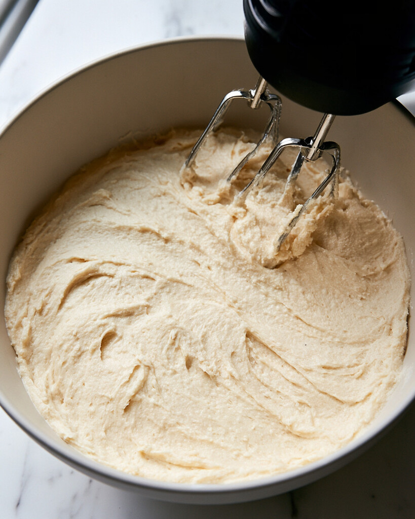 Whipping the brown sugar cream cheese base with a hand mixer in a bowl until fluffy