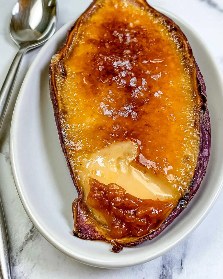 Japanese Sweet Potato Crème Brûlée with Jammy Caramelized Kimchi Japanese sweet potato crème brûlée boat with a cracked golden caramel top showing pale yellow custard and flaky sea salt